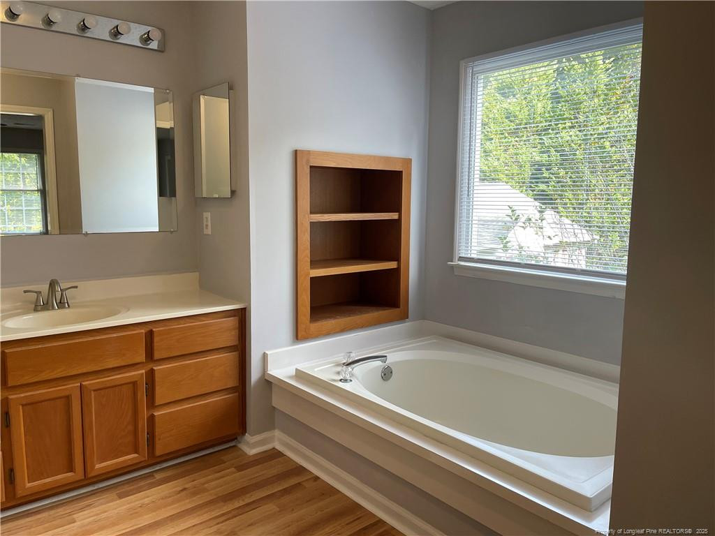 4219 Arbutus Drive, Unit A Raleigh, NC 27612 - Photo 15 of 30 a bathroom with a bathtub and a sink