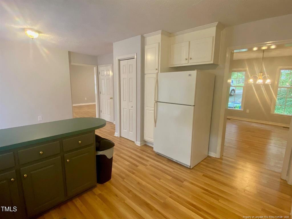 4219 Arbutus Drive, Unit A Raleigh, NC 27612 - Photo 9 of 30 a kitchen with a refrigerator and a sink