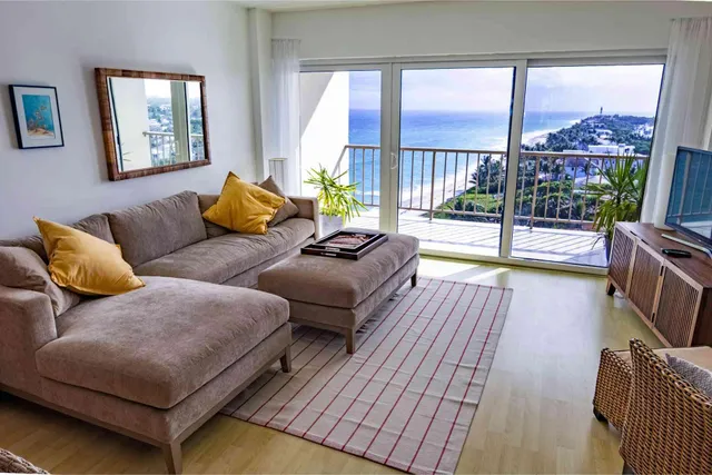 a living room with furniture and a floor to ceiling window