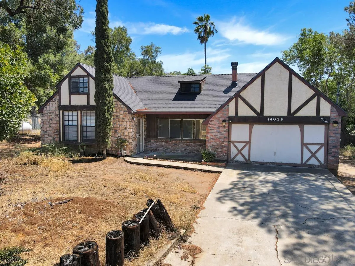 14035 Proctor Valley Road Jamul, CA 91935 - Photo 11 of 53 a front view of a house with a yard and garage