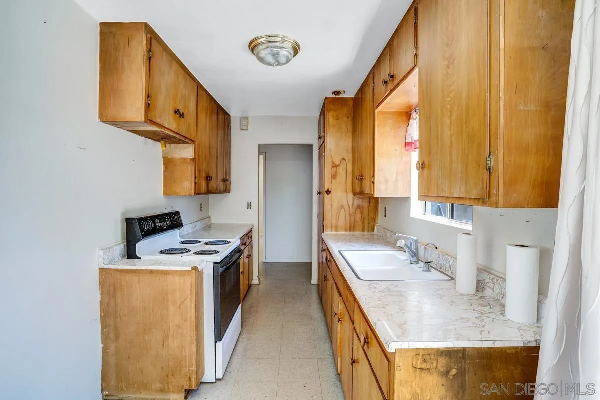 14035 Proctor Valley Road Jamul, CA 91935 - Photo 18 of 53 a bathroom with a granite countertop sink a mirror and a bathtub