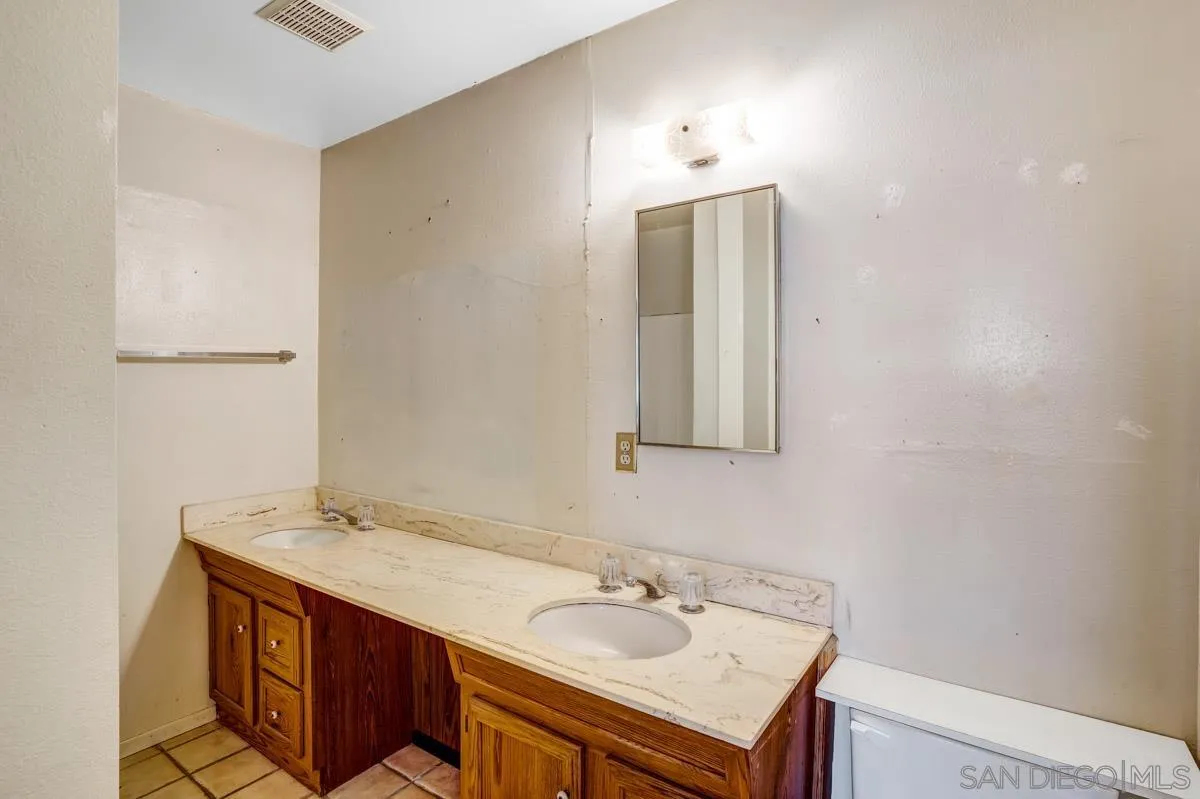 14035 Proctor Valley Road Jamul, CA 91935 - Photo 22 of 53 a bathroom with a sink vanity and mirror