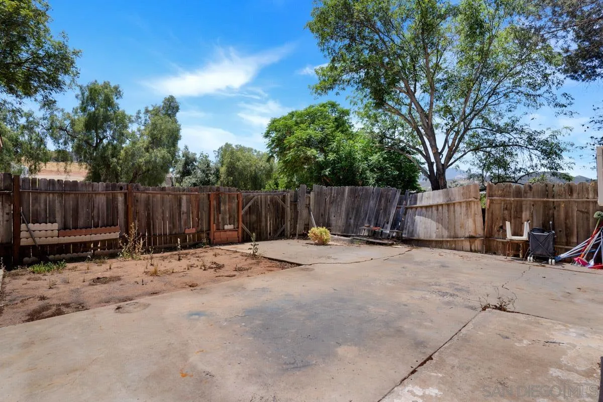 14035 Proctor Valley Road Jamul, CA 91935 - Photo 26 of 53 a backyard of house with wooden fence