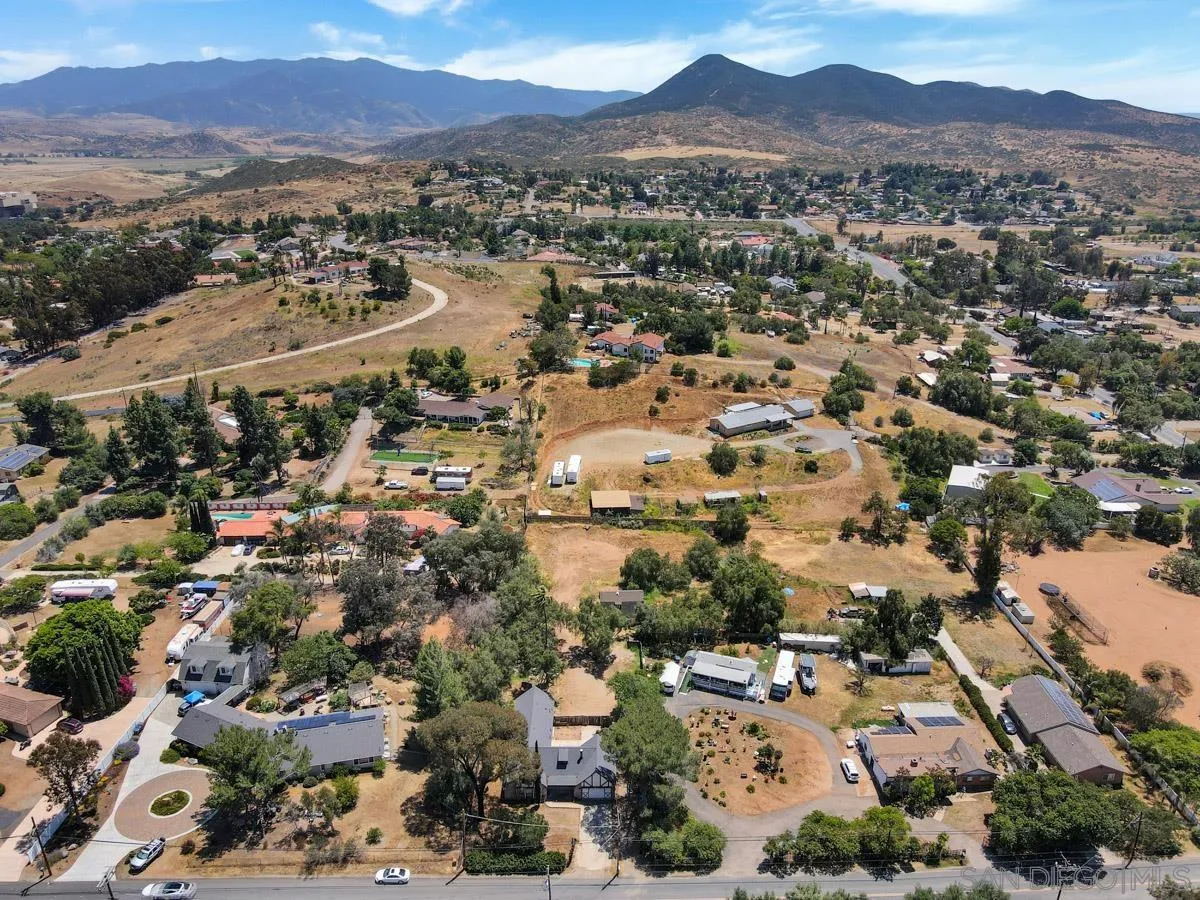 14035 Proctor Valley Road Jamul, CA 91935 - Photo 3 of 53 an aerial view of a city with lots of residential buildings and mountain view in back