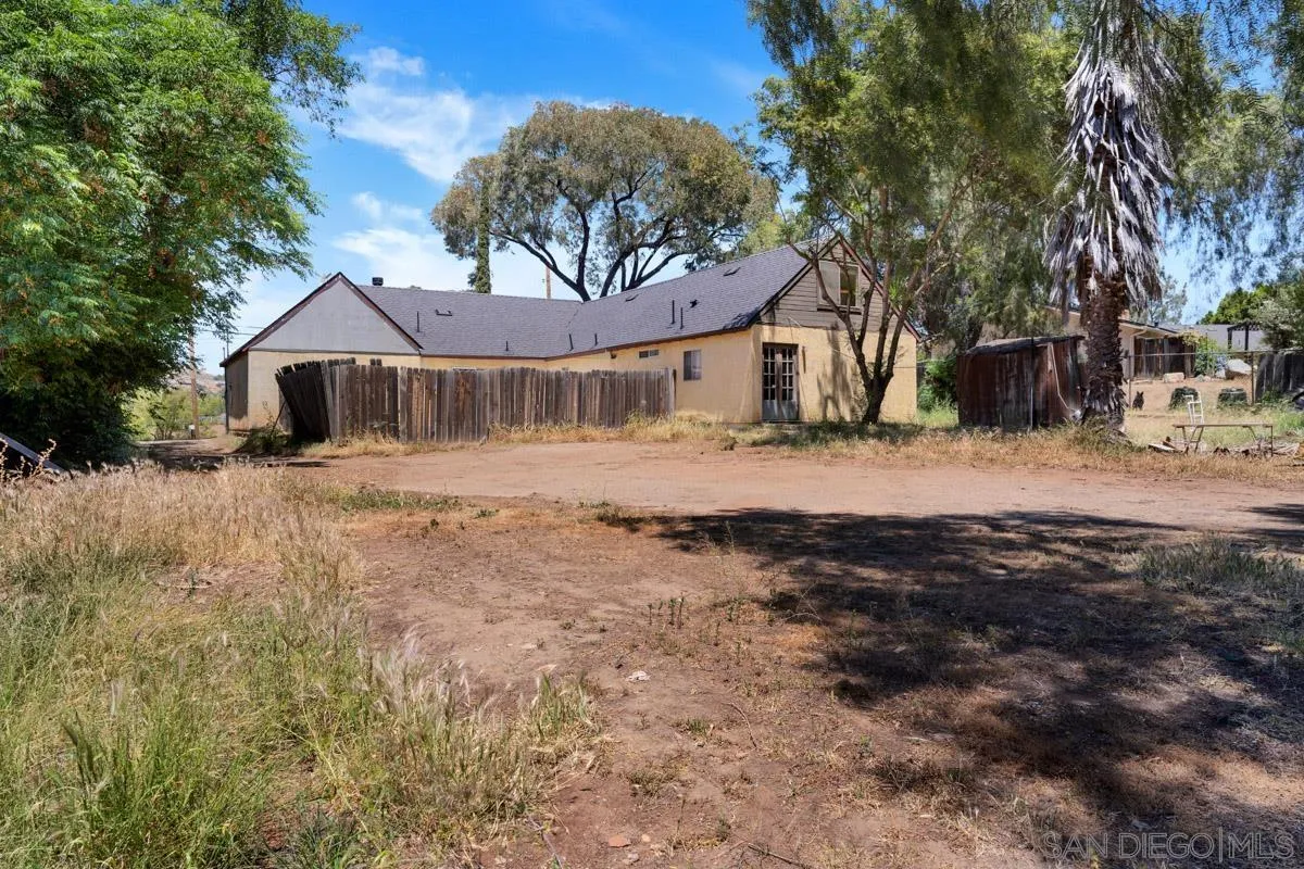 14035 Proctor Valley Road Jamul, CA 91935 - Photo 43 of 53 a front view of a house with a dirt yard and a large tree