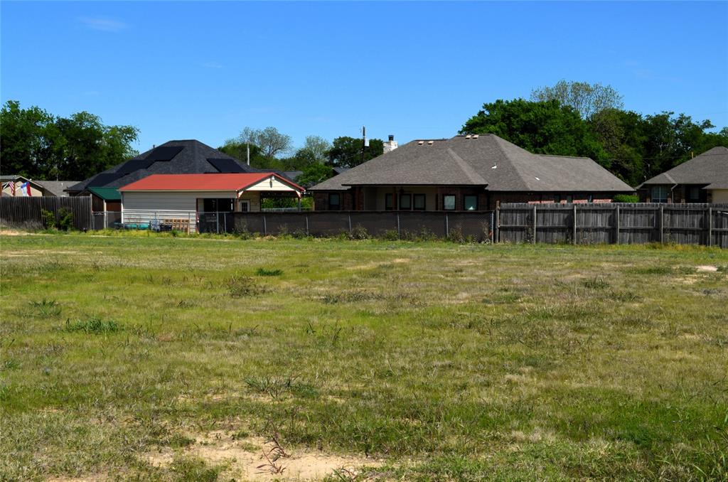 314 Preston Road Mabank, TX 75147 - Photo 2 of 4 a blue swimming pool is sitting in the backyard of house with a yard