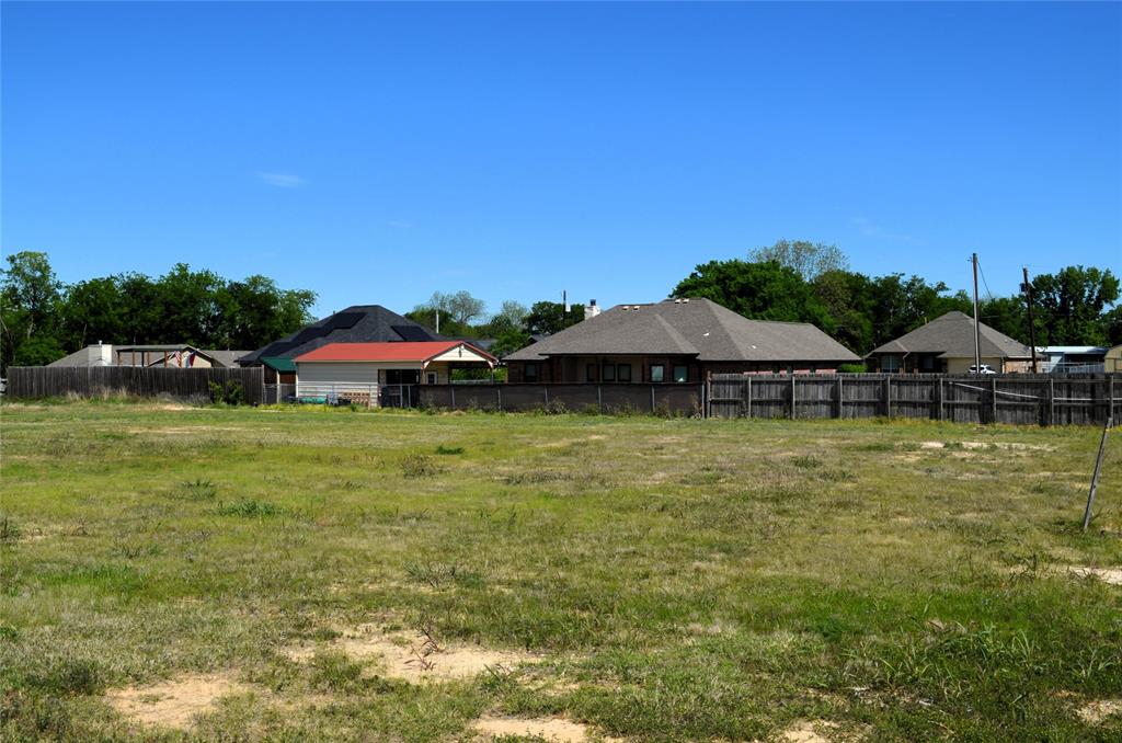 314 Preston Road Mabank, TX 75147 - Photo 4 of 4 a view of a swimming pool with lawn chairs under an umbrella