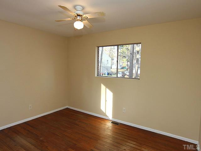 2308 Sheffield Road Raleigh, NC 27610 - Photo 7 of 11 a view of an empty room with wooden floor and a window