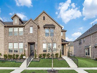 View of front facade featuring a front lawn and brick siding