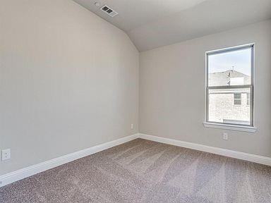 4717 Ladrillo Lane McKinney, TX 75070 - Photo 13 of 24 Unfurnished room featuring light carpet and lofted ceiling