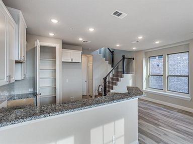 4717 Ladrillo Lane McKinney, TX 75070 - Photo 16 of 24 Kitchen featuring a peninsula, white cabinetry, recessed lighting, light wood finished floors, and dark stone countertops