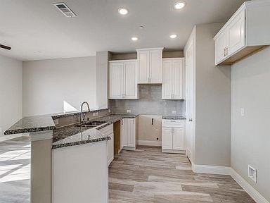 4717 Ladrillo Lane McKinney, TX 75070 - Photo 20 of 24 Kitchen with a peninsula, tasteful backsplash, light wood-type flooring, recessed lighting, and white cabinets