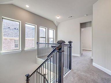 4717 Ladrillo Lane McKinney, TX 75070 - Photo 6 of 24 Hall with an upstairs landing, light colored carpet, vaulted ceiling, and recessed lighting