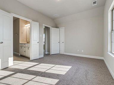 4717 Ladrillo Lane McKinney, TX 75070 - Photo 7 of 24 Unfurnished bedroom featuring light colored carpet, lofted ceiling, and ensuite bath