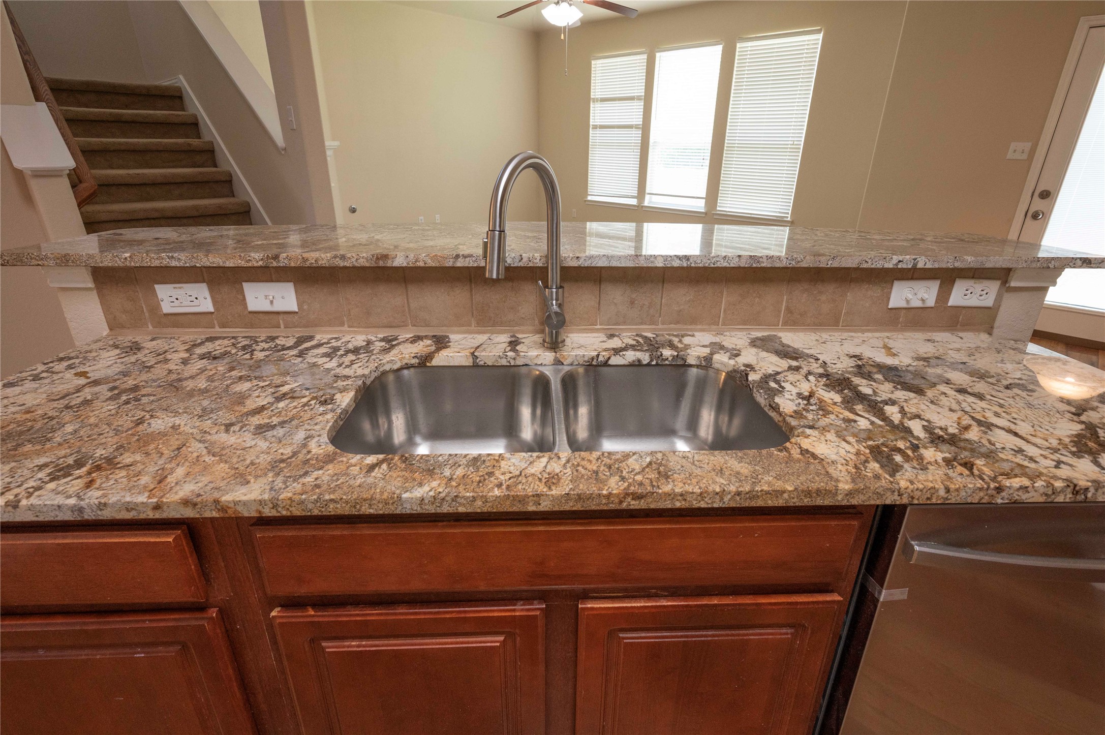 2070 Intrepid Drive Buda, TX 78610 - Photo 8 of 31 A well-appointed kitchen island features a dual-basin sink and ample granite counter space.