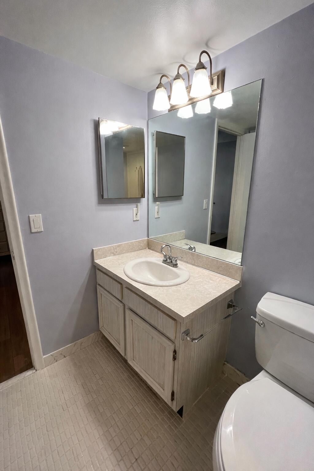 1 Royal Palm Way, Unit 3050 Boca Raton, FL 33432 - Photo 13 of 24 a bathroom with a toilet sink and mirror