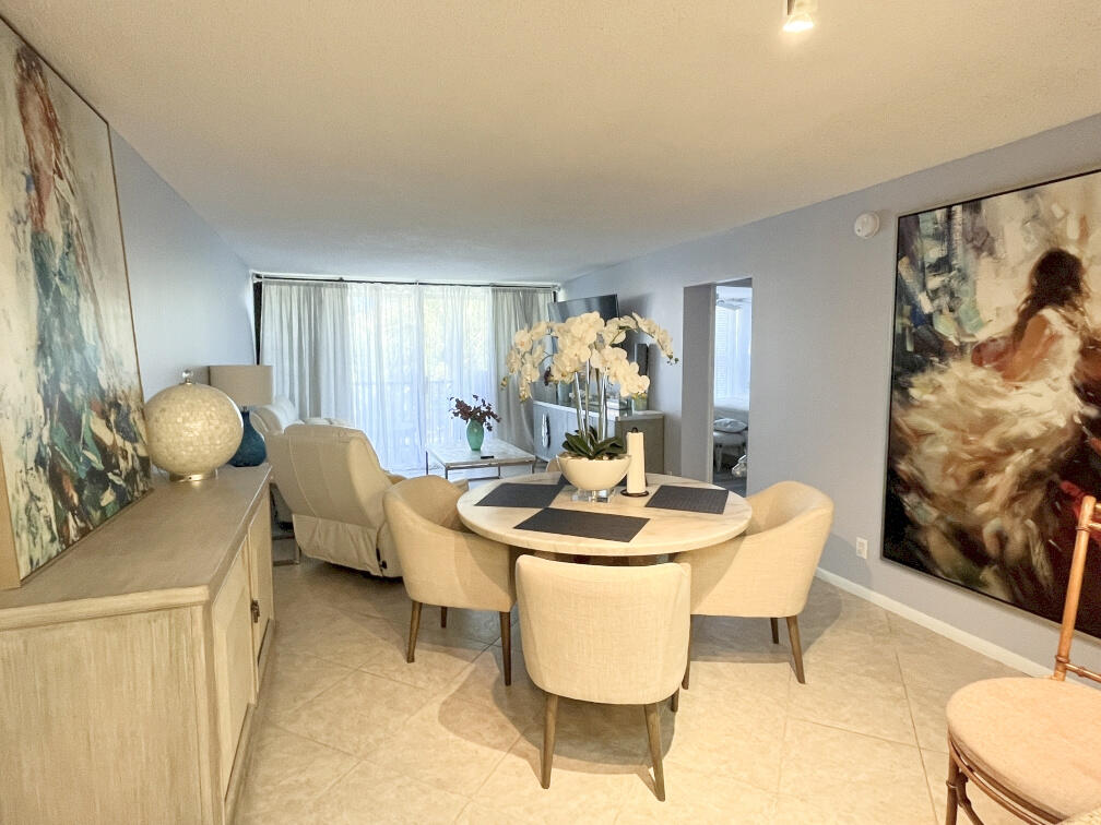 1 Royal Palm Way, Unit 3050 Boca Raton, FL 33432 - Photo 6 of 24 a view of a dining room with furniture and wooden floor