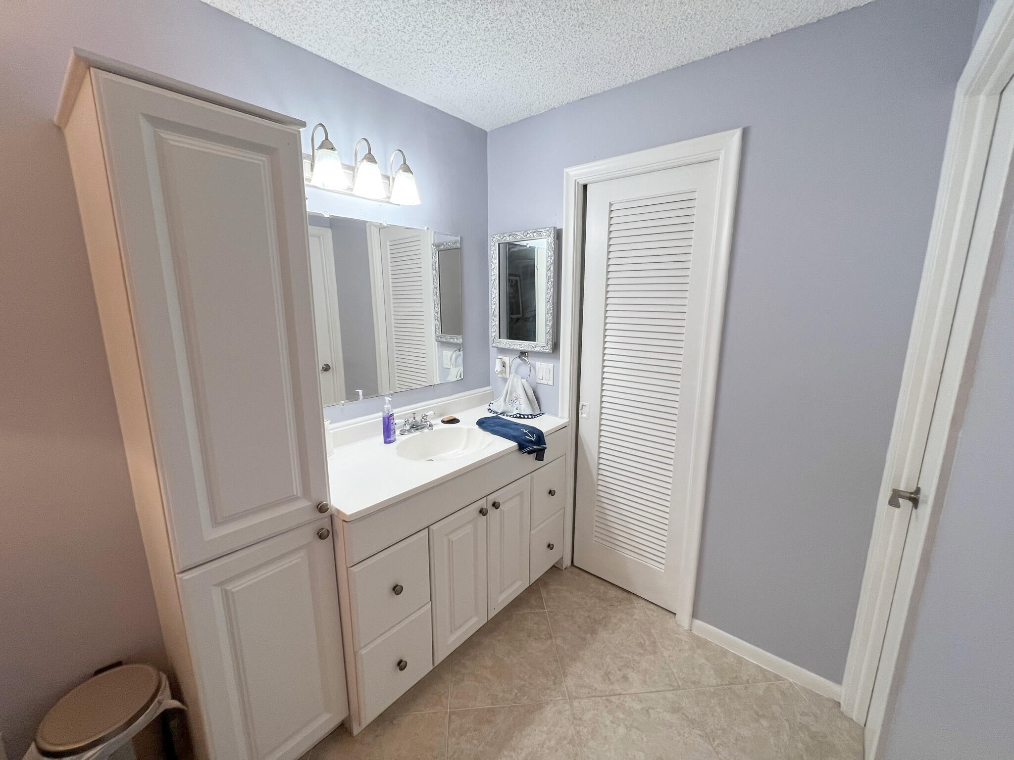 1 Royal Palm Way, Unit 3050 Boca Raton, FL 33432 - Photo 10 of 24 a bathroom with a double vanity sink and a mirror