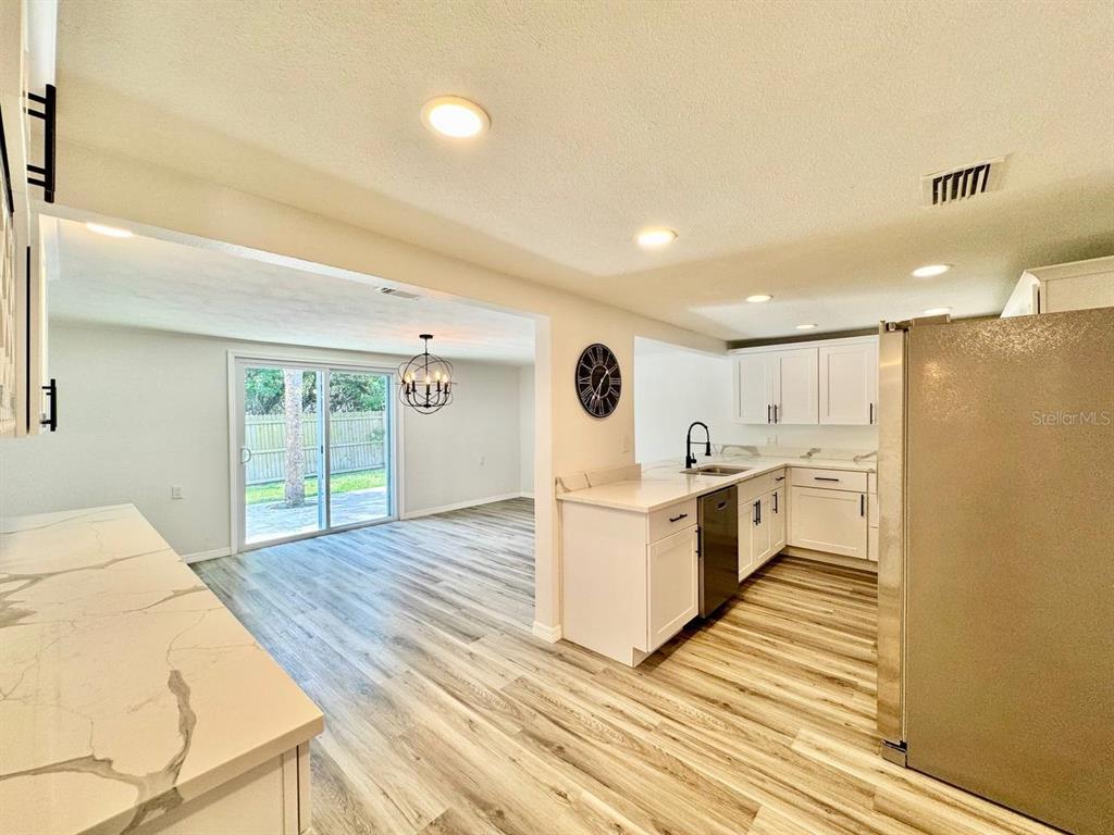 4282 Rudder Way New Port Richey, FL 34652 - Photo 20 of 34 a view of a kitchen with kitchen island wooden floor center island and stainless steel appliances