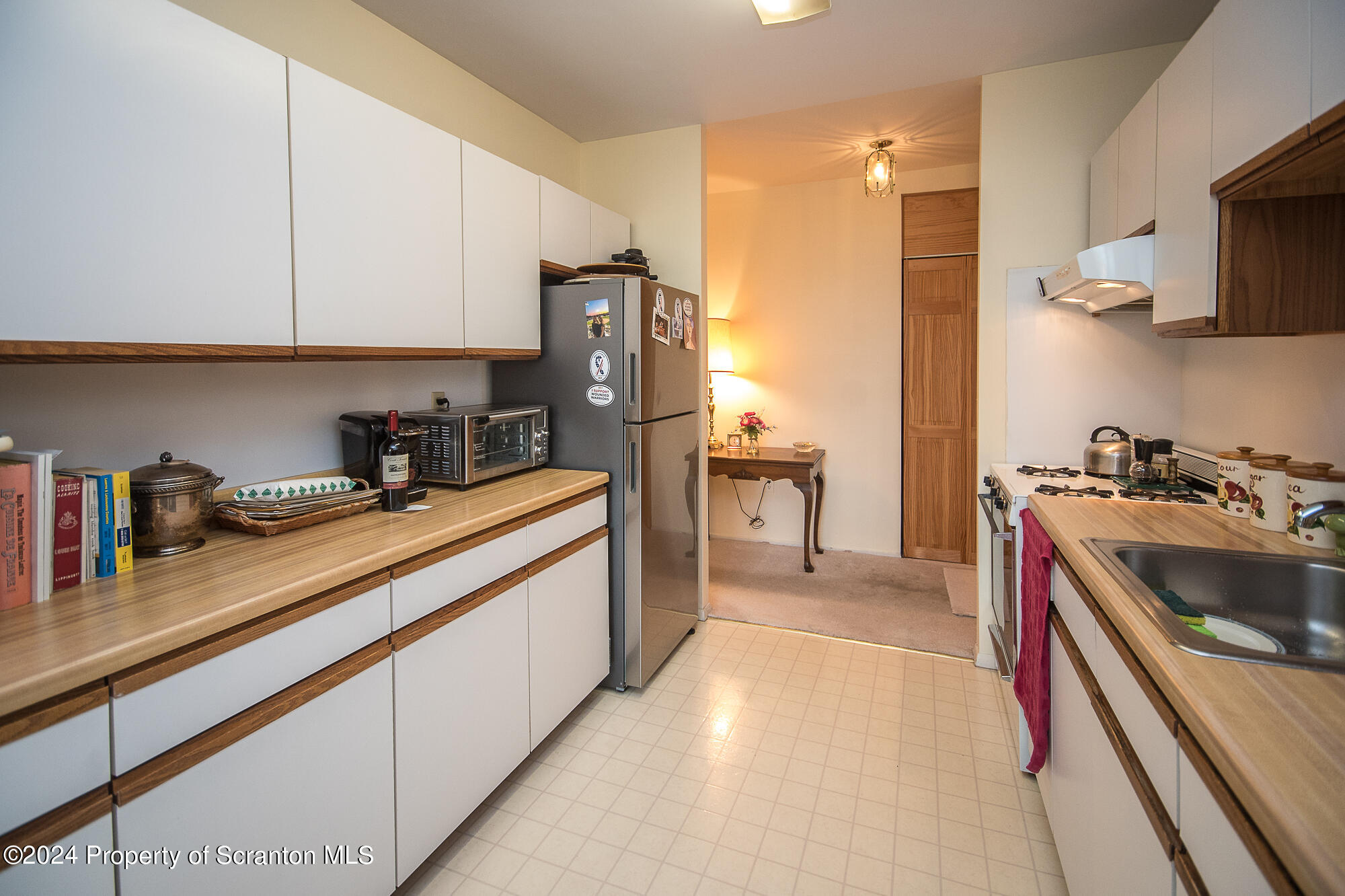 1311 Summit Pointe Scranton, PA 18508 - Photo 5 of 29 a kitchen with kitchen island granite countertop a sink and refrigerator