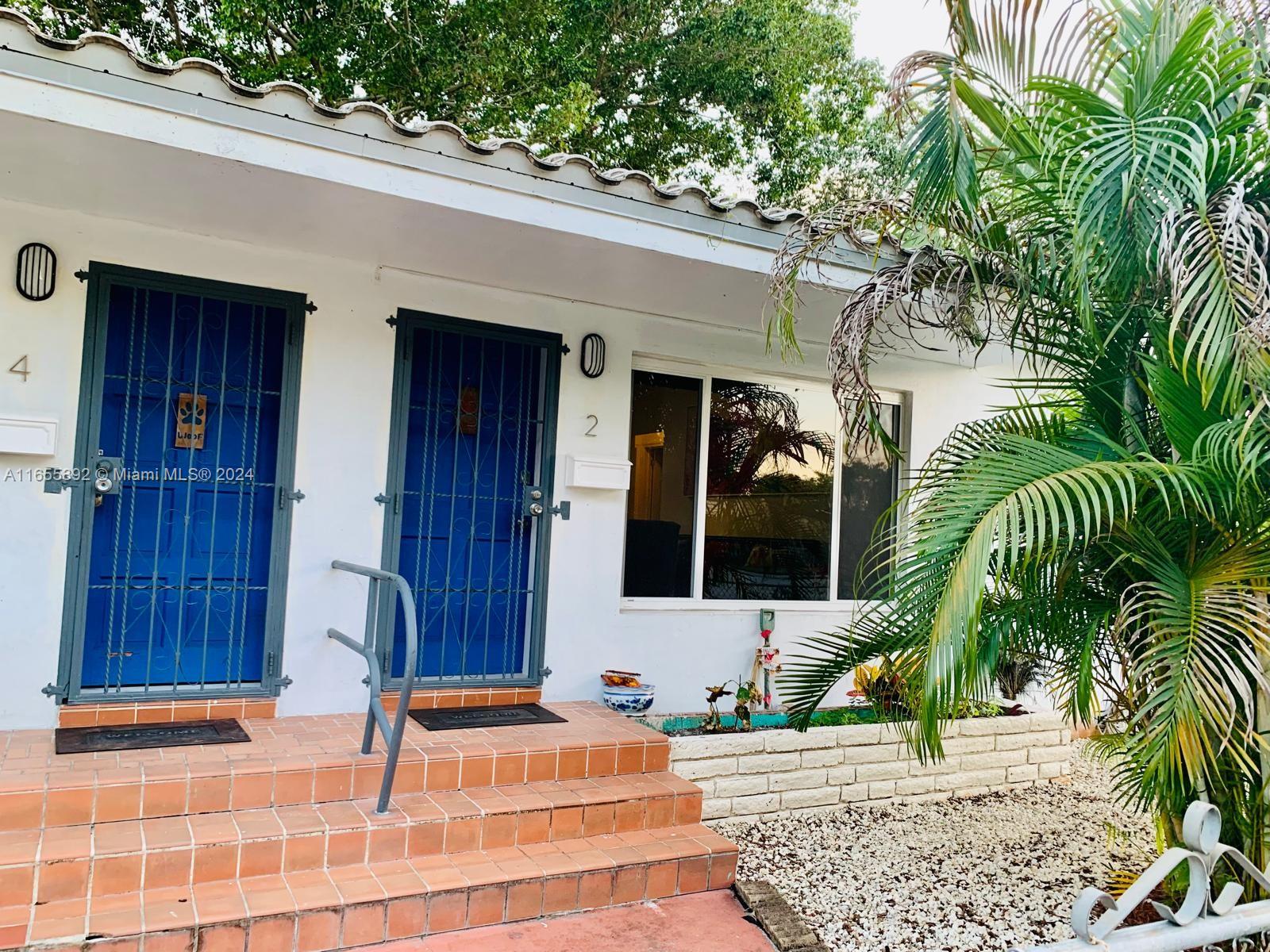 2 Northeast 45th Street, Unit 4 Miami, FL 33137 - Photo 1 of 15 a front view of a house with a garden