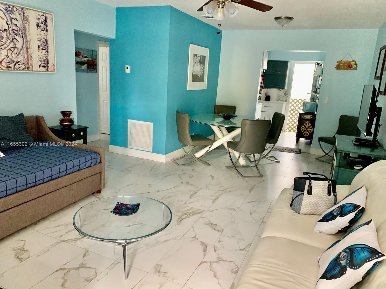 2 Northeast 45th Street, Unit 4 Miami, FL 33137 - Photo 5 of 15 a living room with furniture and wooden floor