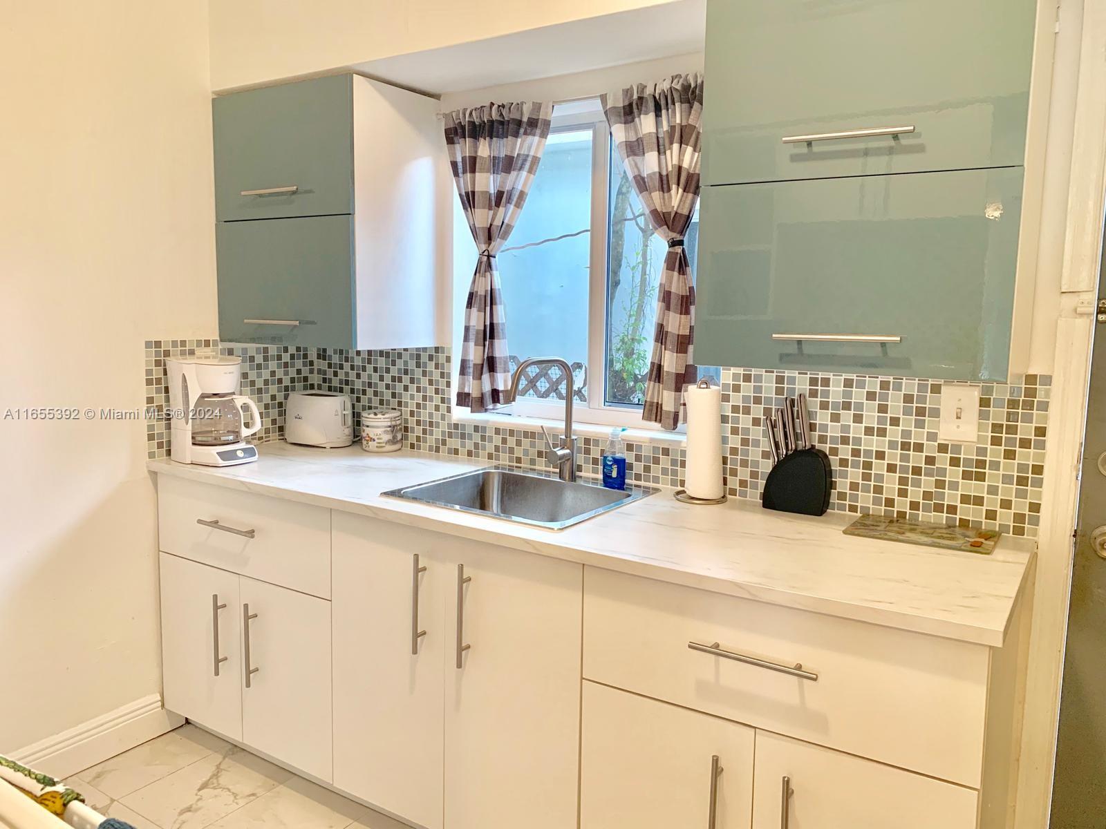 2 Northeast 45th Street, Unit 4 Miami, FL 33137 - Photo 6 of 15 a bathroom with a sink and a mirror