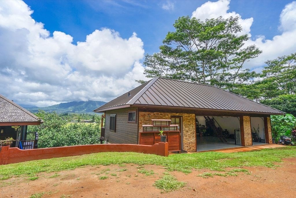 568 U Kamalu Road Kapaa, HI 96746 - Photo 11 of 11 a front view of a house with a garden and trees