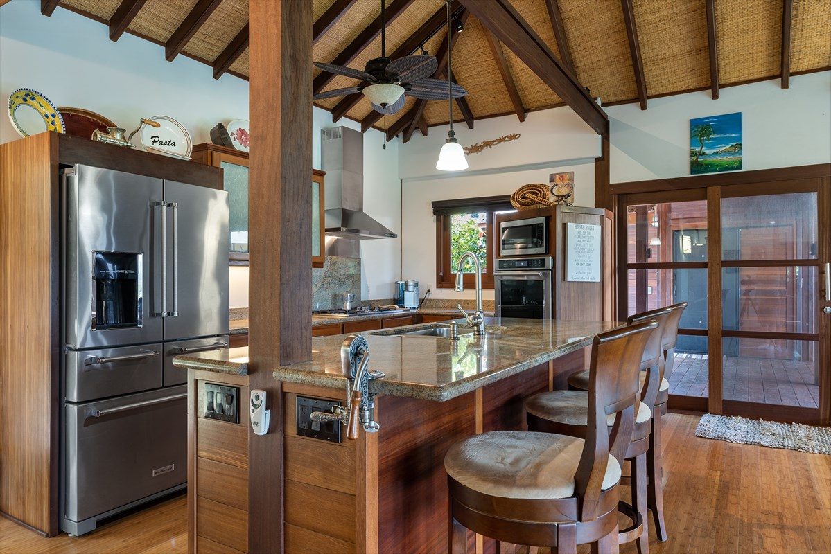 568 U Kamalu Road Kapaa, HI 96746 - Photo 2 of 11 a kitchen with stainless steel appliances granite countertop a table chairs and a refrigerator