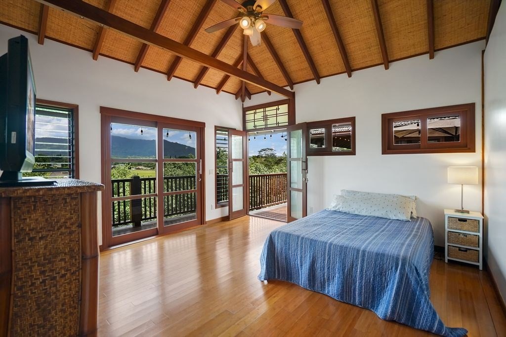 568 U Kamalu Road Kapaa, HI 96746 - Photo 8 of 11 a spacious bedroom with a bed and wooden floor