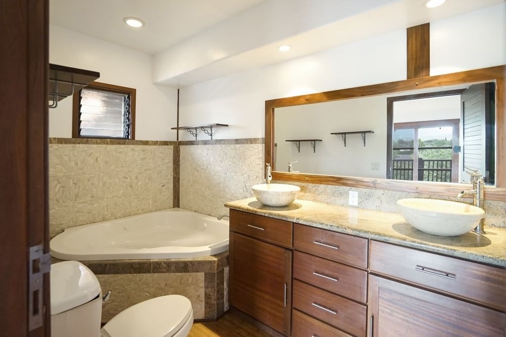 568 U Kamalu Road Kapaa, HI 96746 - Photo 9 of 11 a bathroom with a granite countertop toilet sink and mirror