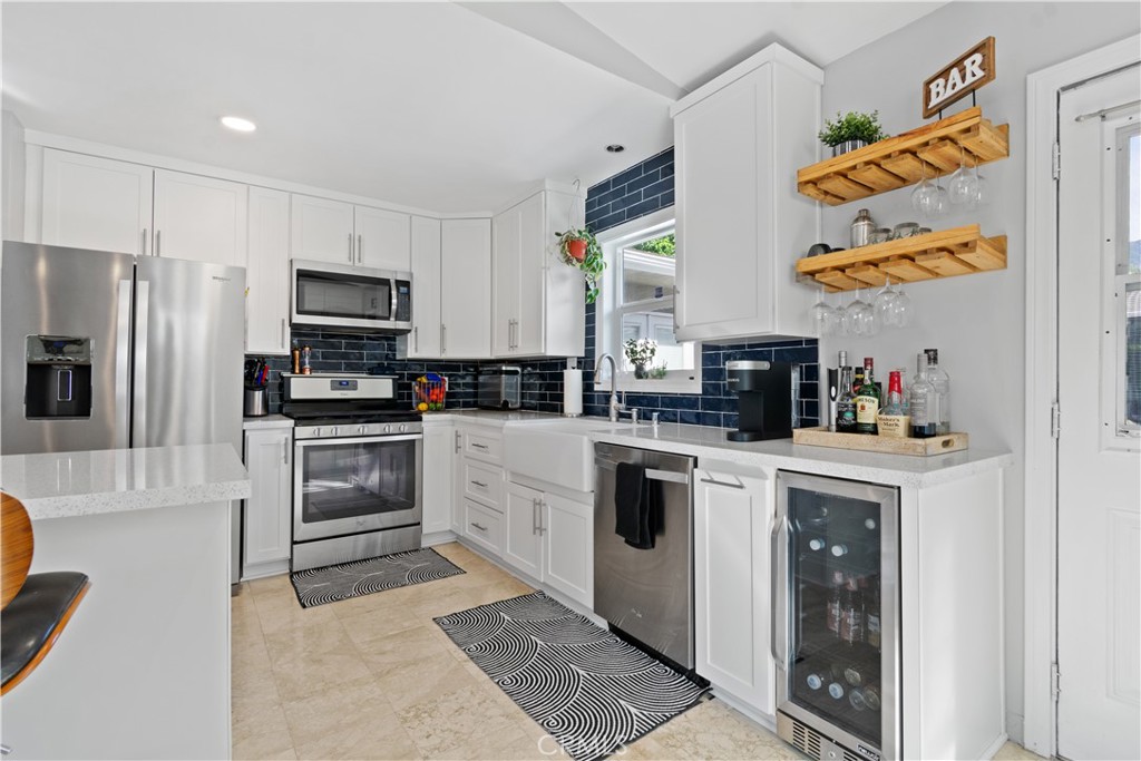 275 Mountain View Street Altadena, CA 91001 - Photo 12 of 30 a kitchen with stainless steel appliances granite countertop a refrigerator sink and stove top oven
