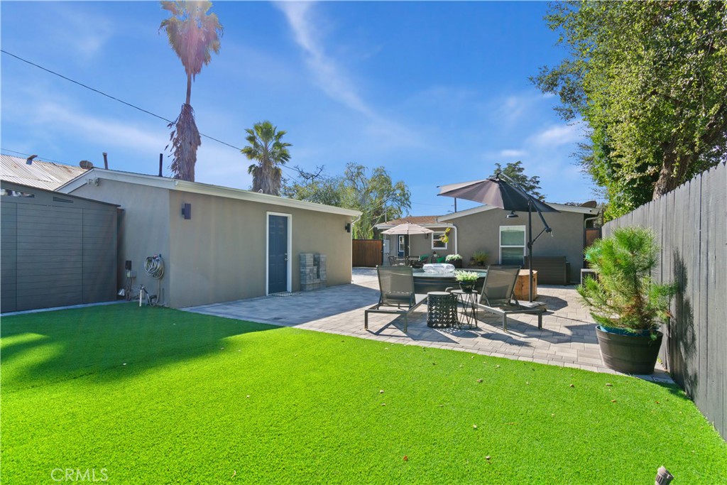 275 Mountain View Street Altadena, CA 91001 - Photo 28 of 30 a view of a patio with table and chairs potted plants and wooden fence