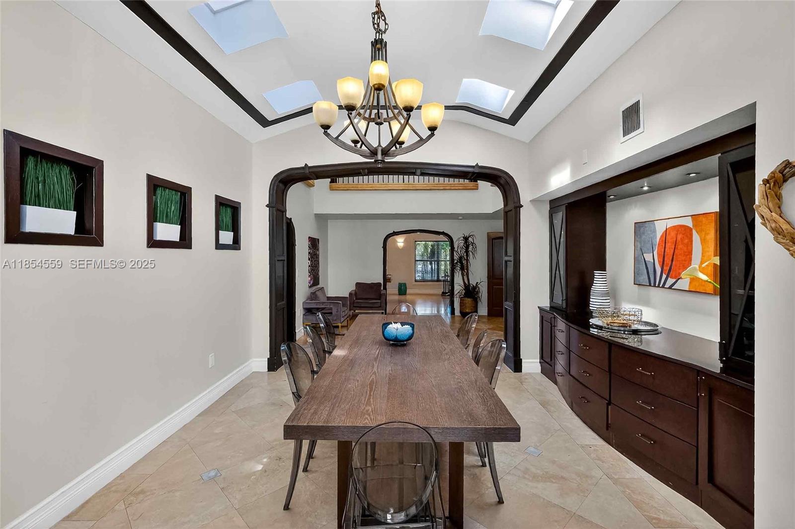 1051 Northeast 89th Street Miami, FL 33138 - Photo 30 of 71 a view of a dining room with furniture chandelier and wooden floor