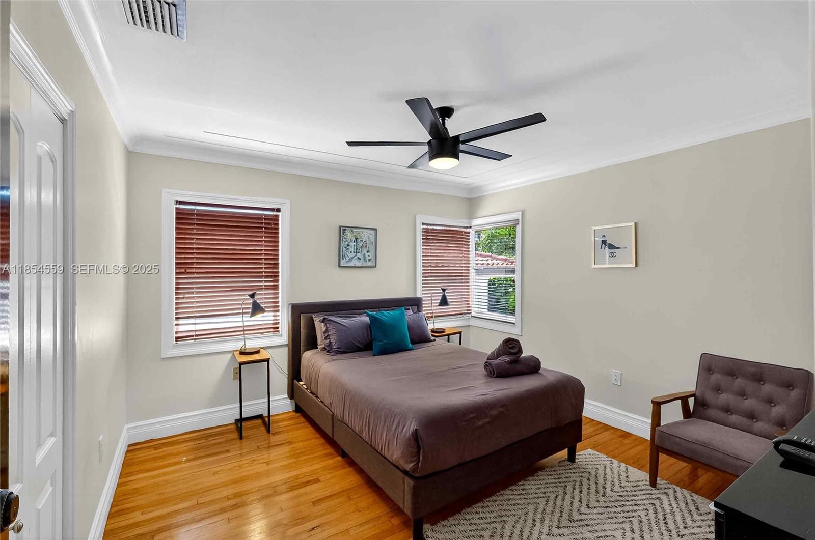 1051 Northeast 89th Street Miami, FL 33138 - Photo 54 of 71 a bedroom with a bed wooden floor and window