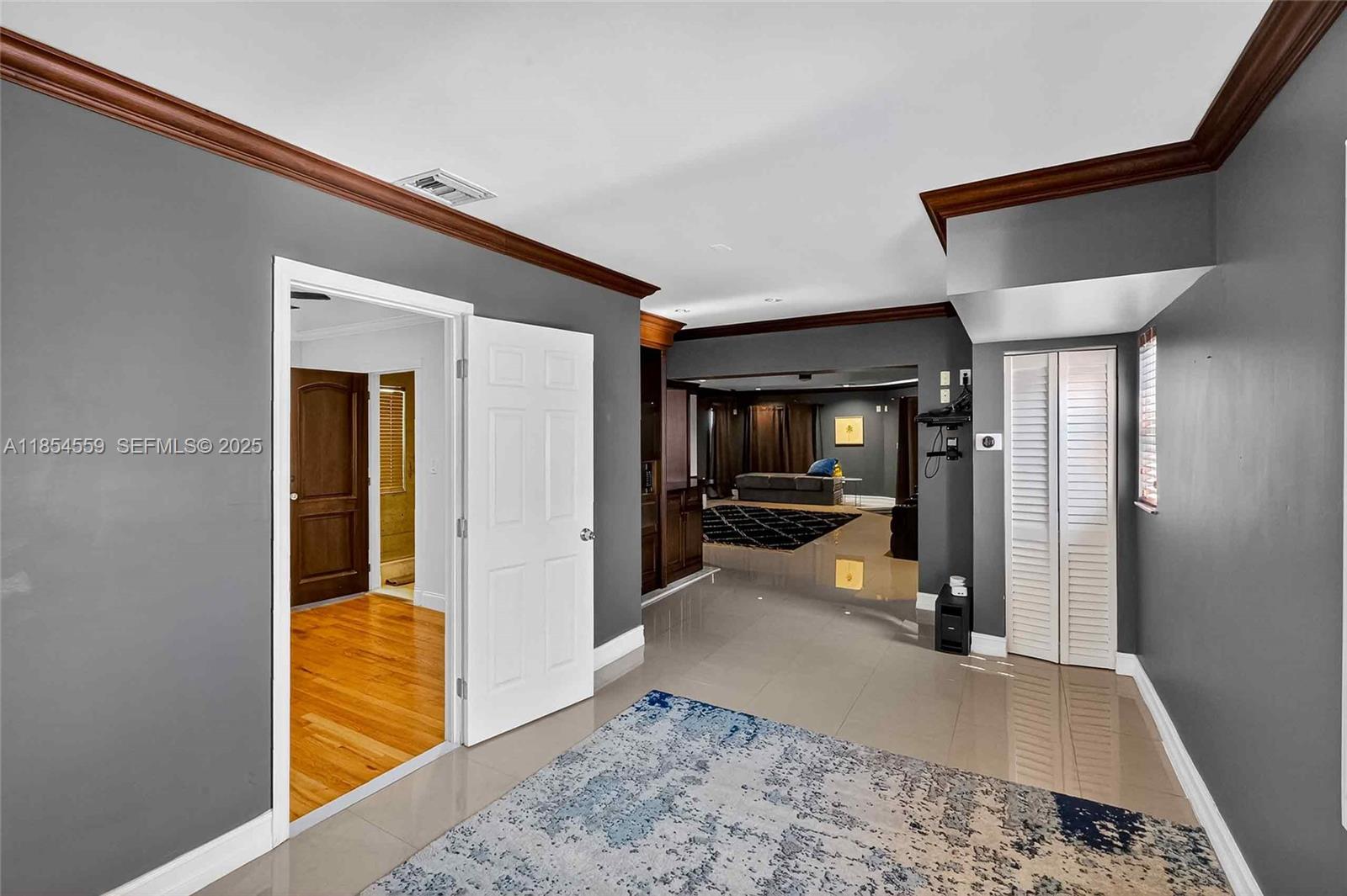 1051 Northeast 89th Street Miami, FL 33138 - Photo 64 of 71 a view of a hallway with wooden floor and a bathroom