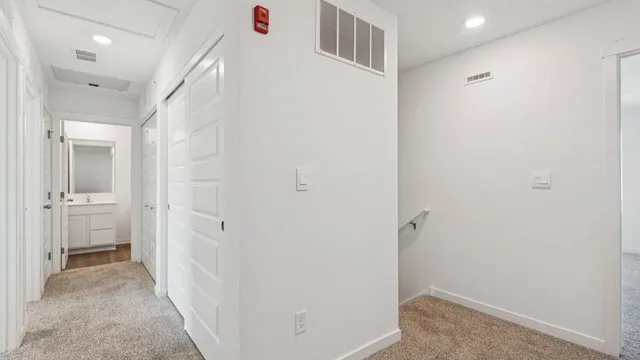 a view of a hallway with a white walls