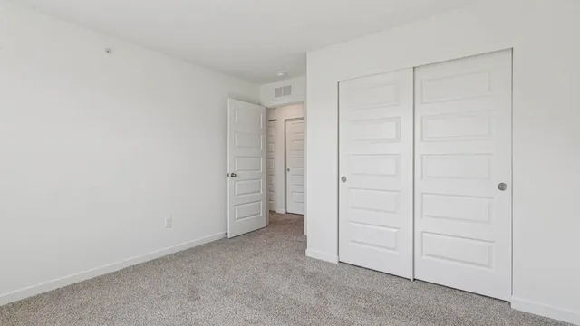 an empty room with closet area