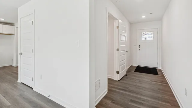 a view of a hallway with wooden floor