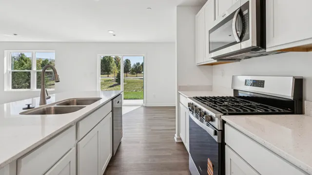 a kitchen that has a sink and a stove