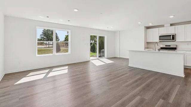 a view of a kitchen with microwave and wooden floor