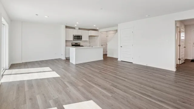 a view of kitchen with refrigerator sink and cabinets