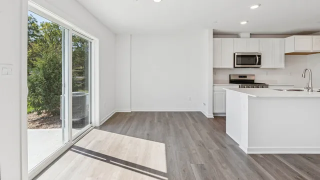 a kitchen with sink a refrigerator and microwave