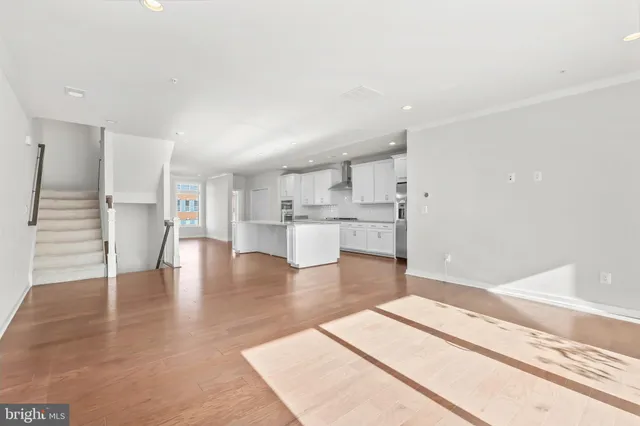 a living room with furniture flat screen tv and a large window