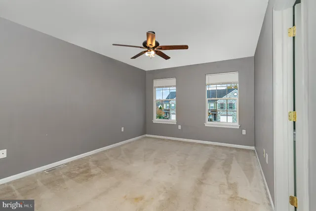 a view of room with a ceiling fan and window