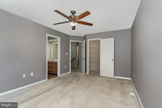 a view of a livingroom with a ceiling fan and window