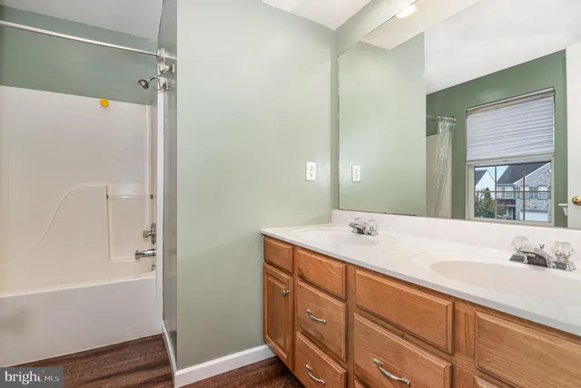 a bathroom with a sink and a mirror with bathtub