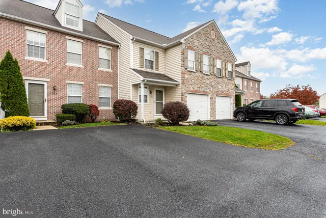 a car parked in front of a brick house