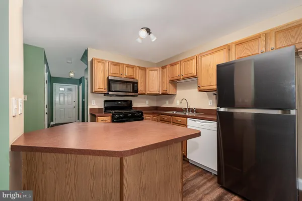 a kitchen with stainless steel appliances a refrigerator and a stove