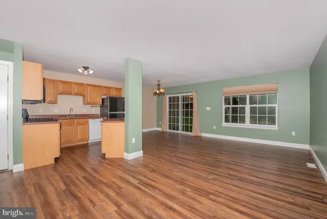 a view of kitchen with granite countertop cabinets and wooden floor